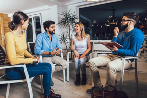 People sitting in a circle at an addiction therapy program