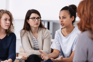 People sitting close together at a women's rehab program session