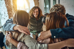 People hugging each other at an alumni program in Michigan