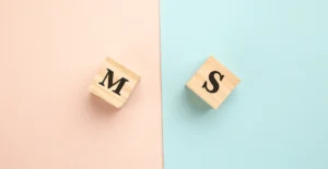 Wooden blocks with the letters “M” and “S” placed on pastel pink and blue backgrounds—symbolizing gender-specific or individualized care options in the rehab center’s treatment programs.